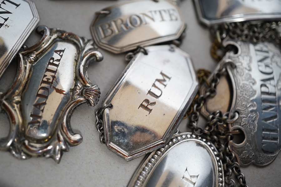 A collection of thirty two silver plated mostly named spirit labels, from the 19th century and 20th century, largest ‘Lisbon’ 6cm wide. Condition - a few where the plate has worn but most good